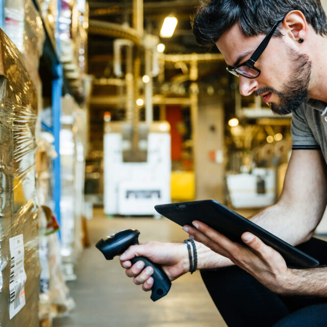 Retail worker with a tablet and scanner