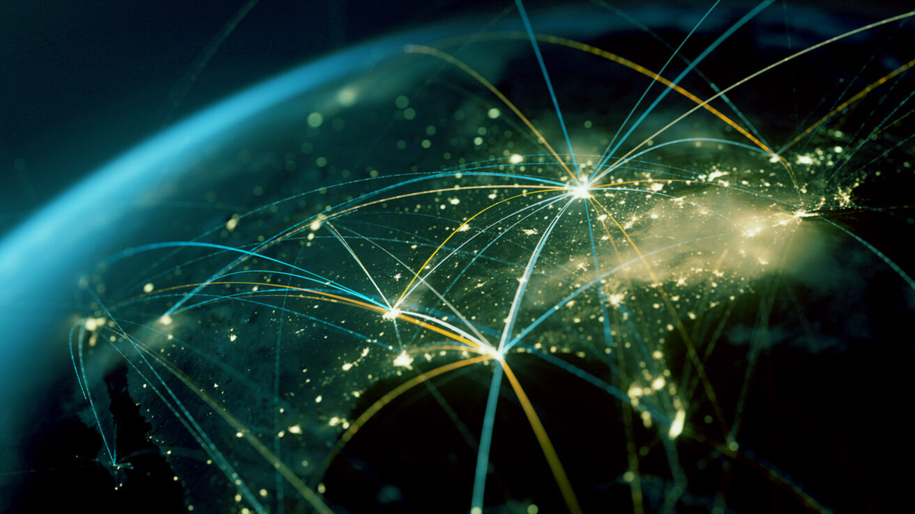 A digital rendering of Earth from space at night showing illuminated cities connected by glowing network lines, depicting global communication and data exchange.