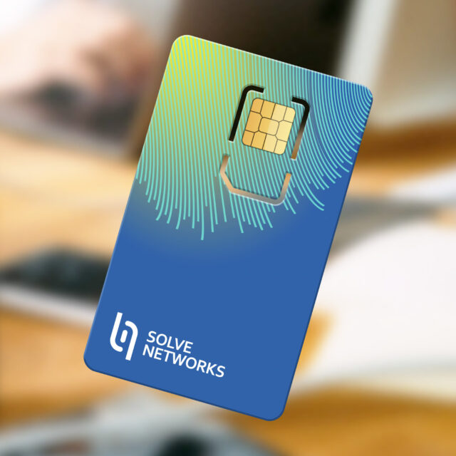A close-up of a credit card-sized chip card with a blue and green gradient design branded with "Solve Networks.