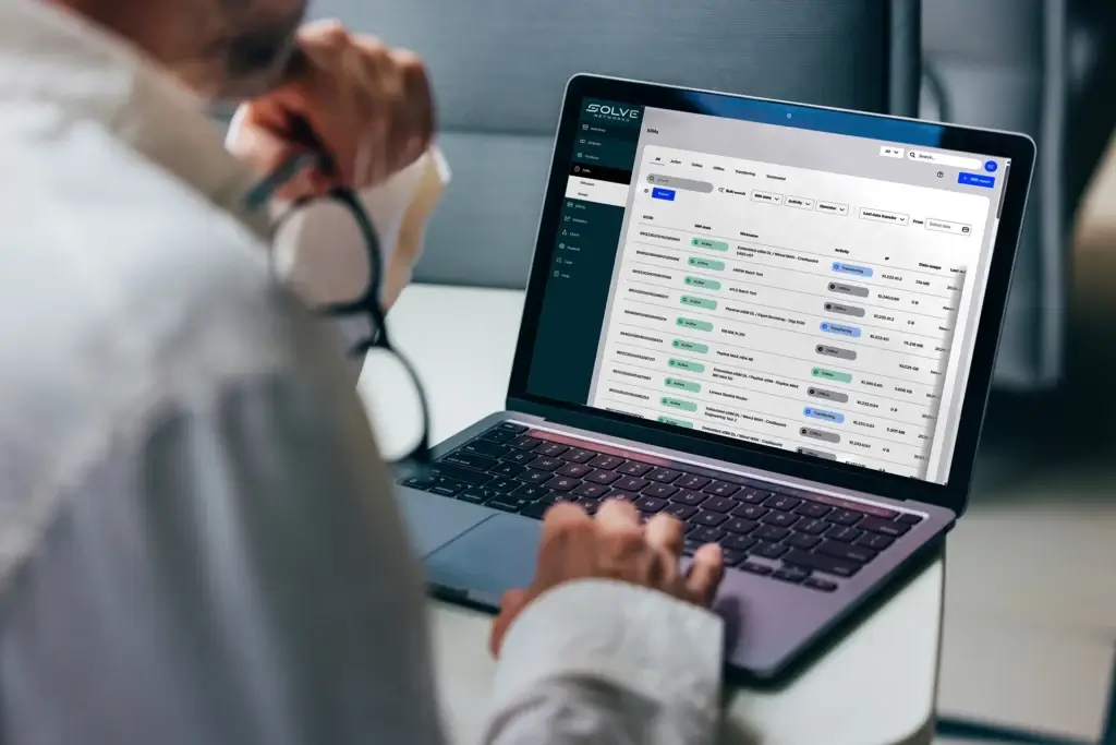 A professional focuses on analyzing detailed business reports displayed on a laptop screen. The graphics include various charts and performance metrics, highlighting statistical trends for comprehensive decision-making in a corporate environment.