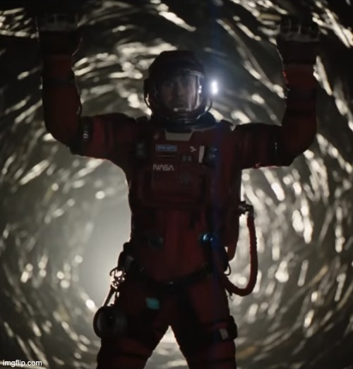 Still shot of Ryan Gosling in character in the film Project Hail Mary. He is in a tunnel in a NASA space suit.